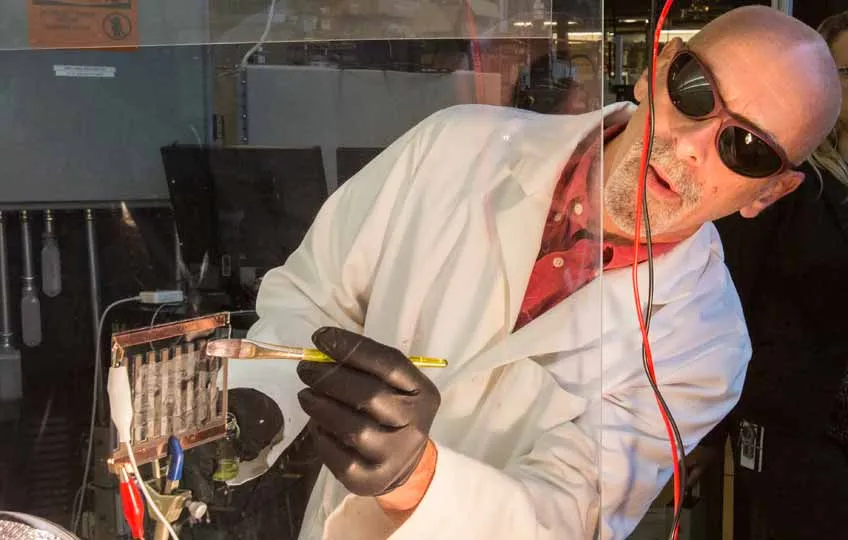 Scientist Paints a Perovskite Solution onto Glass, Creating a Solar Cell Scientist Paints a Perovskite Solution onto Glass, Creating a Solar Cell